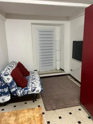 a small room with a bed and a chair at Old Nice appartement entier proche mer et plage et AC in Nice