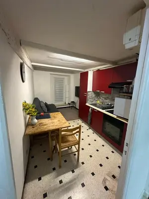 a living room with a table and a kitchen at Old Nice appartement entier proche mer et plage et AC in Nice
