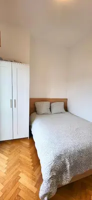 a bedroom with a bed and a white cabinet at Vue mer panoramique, plage et Promenade à pied in Nice