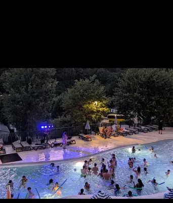 a group of people in a swimming pool at night at Mobilhome Camping 4 étoiles in Cagnes-sur-Mer