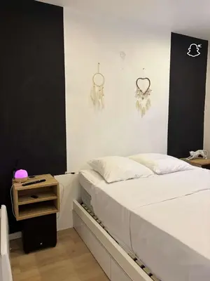 a bedroom with a white bed and a night stand at 3 Pièces avec Terrasse sans vis à vis in Nice
