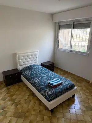 a bedroom with a bed with two towels on it at Appartement 3 chambres avec piscine et parking privé in Nice