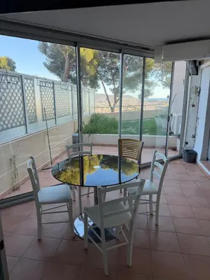 a glass table and chairs on a balcony with a view at Appartement 3 chambres avec piscine et parking privé in Nice