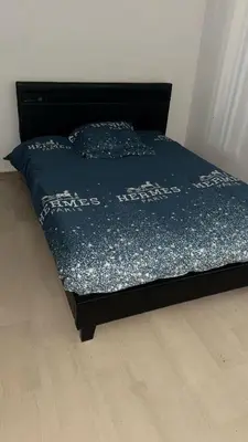 a bed with a blue comforter in a bedroom at Appartement 3 chambres avec piscine et parking privé in Nice