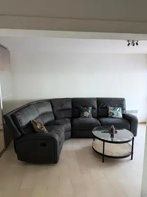 a living room with a black couch and a table at Appartement 3 chambres avec piscine et parking privé in Nice