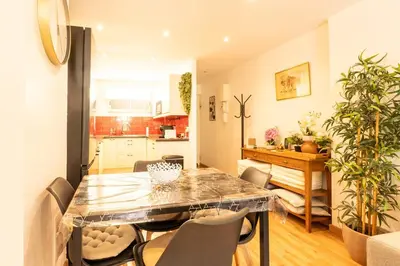 a dining room and kitchen with a table and chairs at Le Bougainvillier in Nice