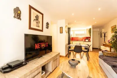 a living room with a large flat screen tv at Le Bougainvillier in Nice