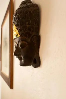 a bronze statue of a head on a wall at Le Bougainvillier in Nice