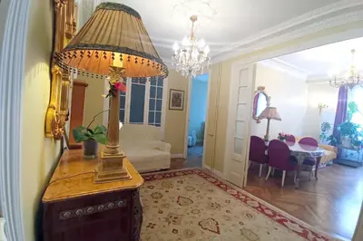 a living room with a lamp on a table at Large bright apartment in the heart of Nice in Nice