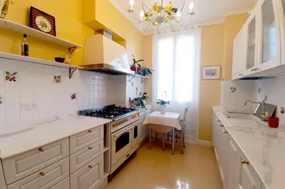 a kitchen with white cabinets and a stove top oven at Large bright apartment in the heart of Nice in Nice
