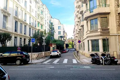 a city street with cars parked on the street at Large bright apartment in the heart of Nice in Nice