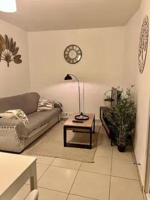 a living room with a couch and a coffee table at Appartement calme proche Nice à 20 min des plages in Colomars