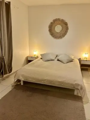 a bedroom with a white bed and a window at Appartement calme proche Nice à 20 min des plages in Colomars