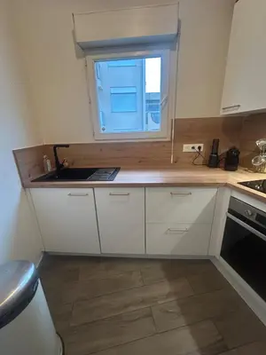 a kitchen with a sink and a window at Duplex close to the sea with parking in Nice