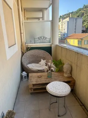 a white bathroom with a toilet and a sink at Duplex close to the sea with parking in Nice