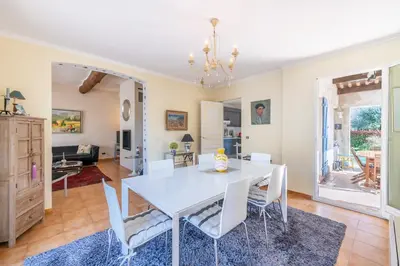 a dining room with a white table and chairs at Villa in Cagnes-sur-Mer in Cagnes-sur-Mer