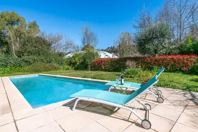 a blue chair sitting next to a swimming pool at Villa in Cagnes-sur-Mer in Cagnes-sur-Mer