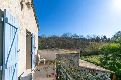 a house with a white door and a chair on a porch at Villa in Cagnes-sur-Mer in Cagnes-sur-Mer