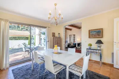 a dining room with a white table and chairs at Villa in Cagnes-sur-Mer in Cagnes-sur-Mer