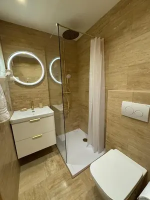 a bathroom with a shower and a toilet and a sink at Le California front de mer in Cagnes-sur-Mer