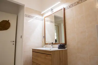 a bathroom with a sink and a mirror at Duplex carré d'or au calme sur cour 100m de la plage in Nice