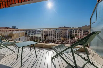 two chairs and a table on a balcony with a view at Le Concorde in Saint-Laurent-du-Var