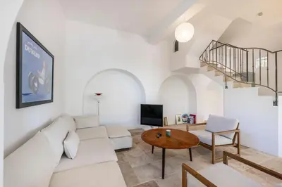 a living room with a white couch and a table at House on the Hill in Nice