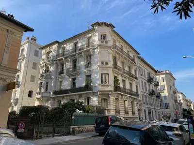 a large white building with cars parked in front of it at Chambre Gounod in Nice