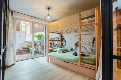 a bedroom with a bunk bed with a large window at Loft proche du port de Nice - 6 pers - Parking in Nice