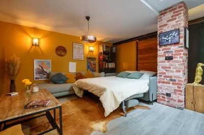 a living room with a bed and a couch at Loft proche du port de Nice - 6 pers - Parking in Nice
