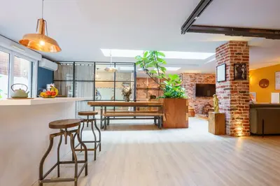 a kitchen and living room with a table and chairs at Loft proche du port de Nice - 6 pers - Parking in Nice
