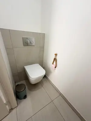 a bathroom with a white toilet and a trash can at Lympia Riviera Residence in Nice