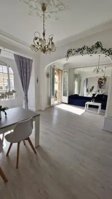 a large living room with a table and a couch at Chateauneuf in Nice