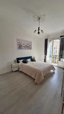a bedroom with a large bed and a window at Chateauneuf in Nice