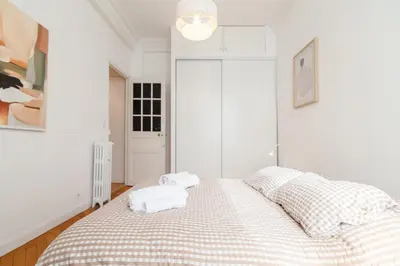 a white bedroom with a bed with towels on it at Maison Bianchi - Durante - downtown in Nice