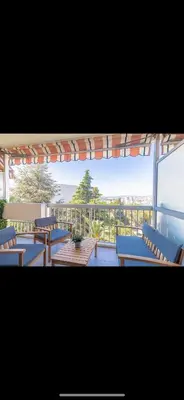 a view of a balcony with blue tables and chairs at Studio cosy Vue mer in Nice