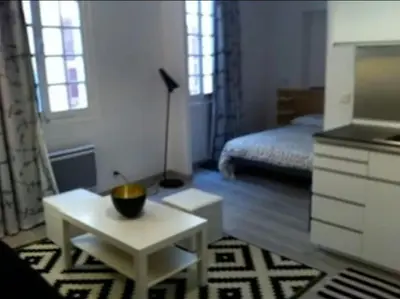 a room with a bed and a table with a bowl on it at Place Rossetti - Charming Apartment in Nice