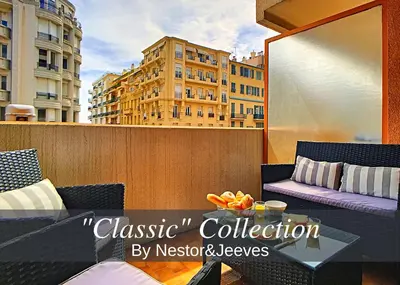 a balcony with a table and chairs and buildings at Nestor&Jeeves - CARDELINE TERRASSE - Very close sea - Spacious in Nice