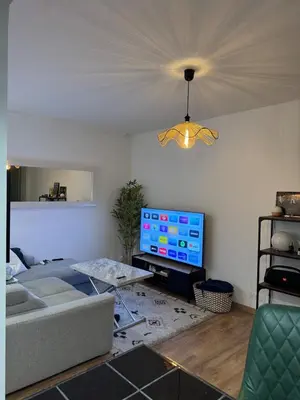 a living room with a couch and a flat screen tv at 2 pièces rénové avec magnifique vue mer et parking in Nice