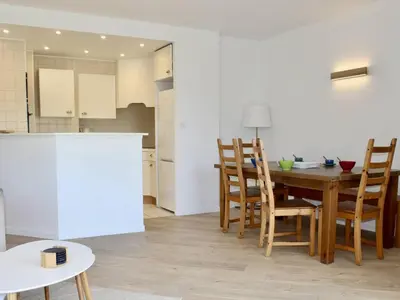 a kitchen and dining room with a table and chairs at Appartement refait à neuf, climatisé - familles - FR-1-252A-143 in Cagnes-sur-Mer