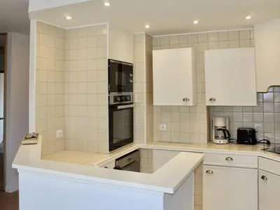 a kitchen with white appliances and white cabinets at Appartement refait à neuf, climatisé - familles - FR-1-252A-143 in Cagnes-sur-Mer