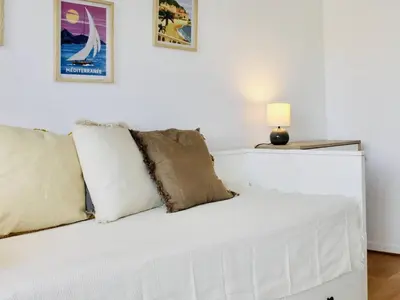 a white couch with pillows on it in a room at Appartement refait à neuf, climatisé - familles - FR-1-252A-143 in Cagnes-sur-Mer