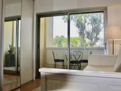 a living room with a view of a table and chairs at Appartement refait à neuf, climatisé - familles - FR-1-252A-143 in Cagnes-sur-Mer