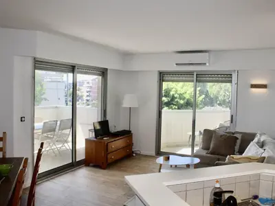 a living room with a couch and a table at Appartement refait à neuf, climatisé - familles - FR-1-252A-143 in Cagnes-sur-Mer