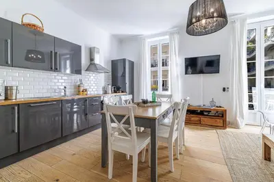a kitchen with a table and chairs in it at Wide & Central 3 Bdr - AC & Balcony in Nice