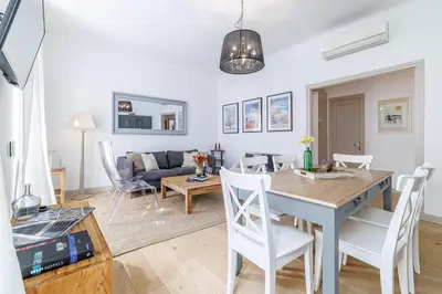 a living room and dining room with a table and chairs at Wide & Central 3 Bdr - AC & Balcony in Nice