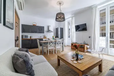 a living room with a couch and a table at Wide & Central 3 Bdr - AC & Balcony in Nice