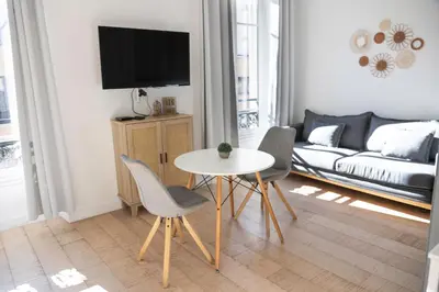 a living room with a table and chairs and a couch at Cozy apartment Nice center in Nice