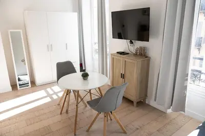 a bedroom with a white bed with two towels on it at Cozy apartment Nice center in Nice