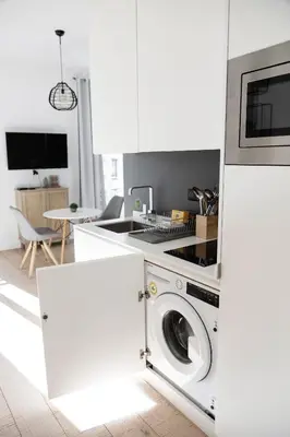 a white kitchen with a washing machine in it at Cozy apartment Nice center in Nice